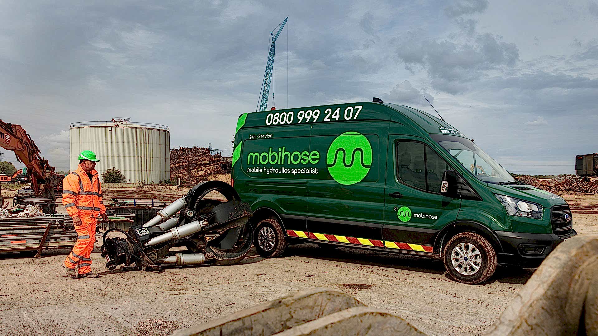 03-Mobile-hydraulic-hose-repair-1920 Green Mobihose van with engineer next to hydraulic demolition attachment.