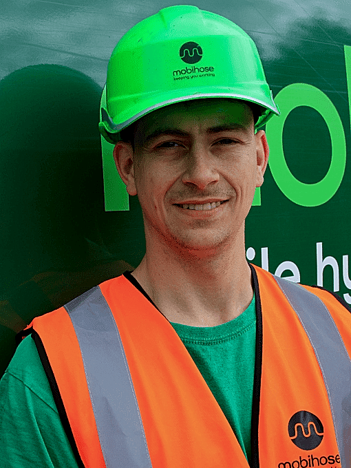 Alex Stephens, Mobihose engineer in front of green van.